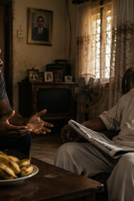 A son voicing his frustrations while his father responds with composure, showing the power of reflection over reaction