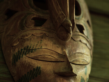 An intricately carved wooden mask preserved with care, symbolising the sacred connection between communities and their ancestors