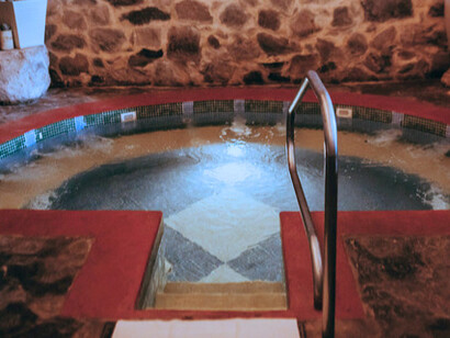 The space is enclosed by thick stone walls made of irregular rocks, giving it a handcrafted, old-world feel