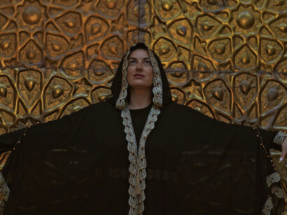 Her gesture of openness reflects the emotional depth found in Mosteghanemi's trilogy, where personal battles for love and freedom resonate deeply with readers