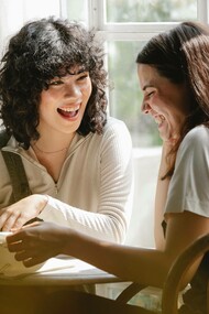 A couple of friends sharing a laugh during their break at their workplace