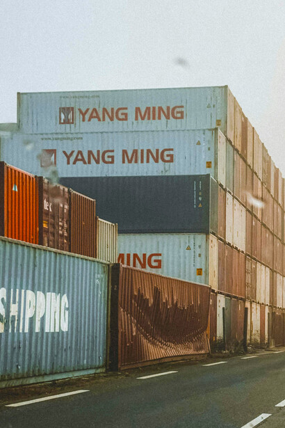 Rows of stacked containers at a freight yard awaiting distribution