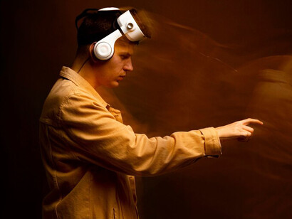 A man engaging with a virtual world through VR glasses