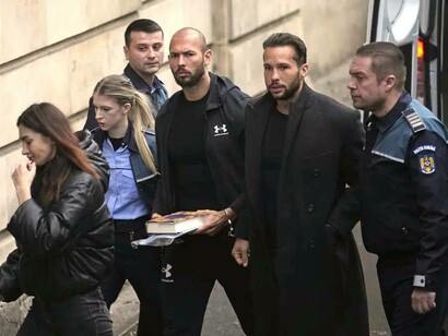 Andrew Tate being ushered into the police station alongside his brother, Tristan Tate in Romania