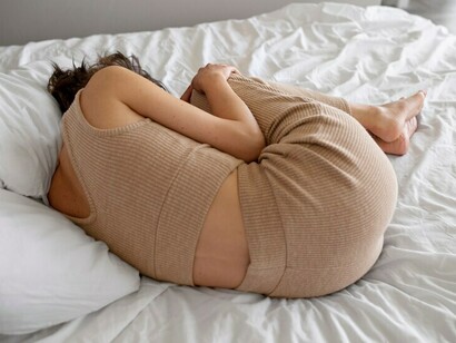 Flat lay of a woman experiencing anxiety, depicting OCD-related distress