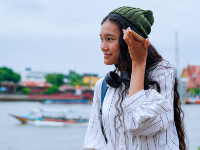 Woman interacting with an artificial intelligence chatbot on a smartphone