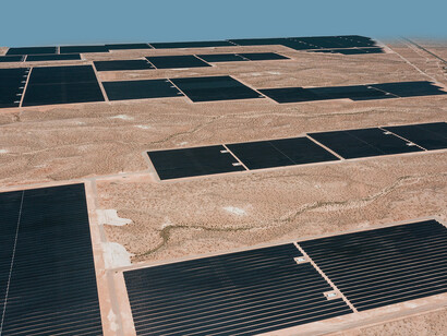 United States: A sweeping aerial shot of a desert solar farm under clear skies