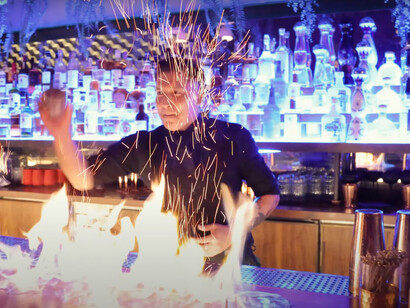 A bartender crafts a flaming cocktail at Le Grand Restaurant in Los Angeles, United States