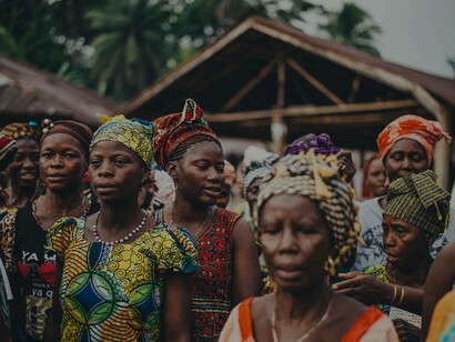 African women huddled together to celebrate their culture and show pride in their traditions