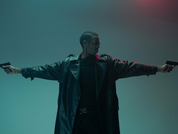 A leather-clad figure prepared for battle with arms outstretched, symbolizing the rebellion against systems of control at the heart of The Matrix