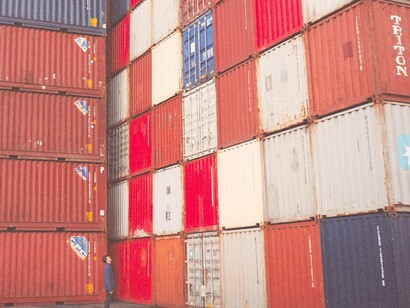 Man with multi coloured shipping containers