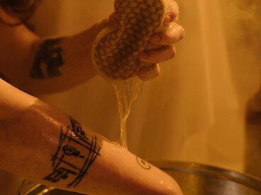 A woman washes her hands in a bathroom, focusing on cleanlines