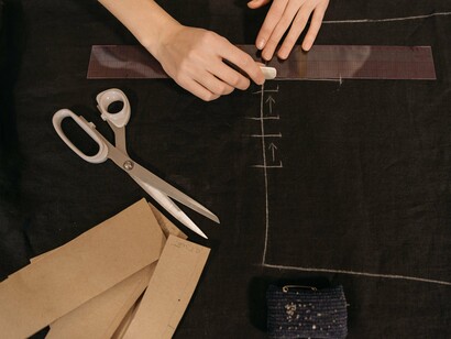 A garment-making workspace with cutting patterns and tailoring equipment, reflecting the design process that turns ideas into clothing