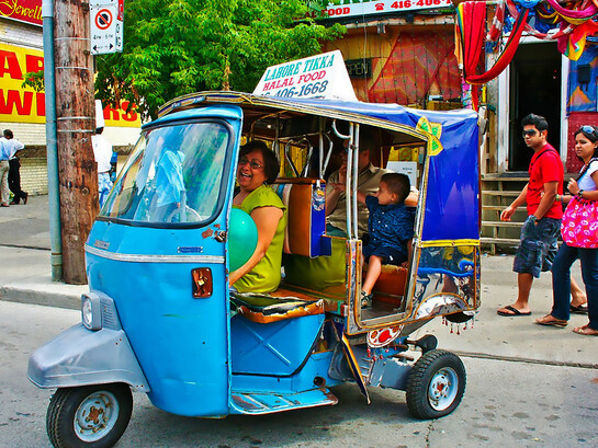 Tourists ride the iconic Tikka Taxi rickshaw through the streets of Lahore, Pakistan