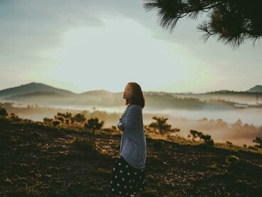 Dalat, Lâm Đồng, Vietnam a woman standing on a mountain taking in the scenic view