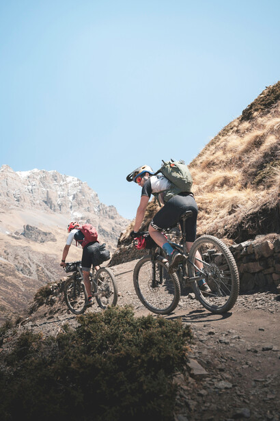 Riders exploring Nepal’s rugged landscapes on a dirt road bike adventure
