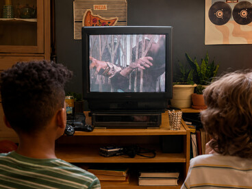 Pair of teens enjoying retro video games on a vintage TV, capturing the nostalgia of classic gaming culture