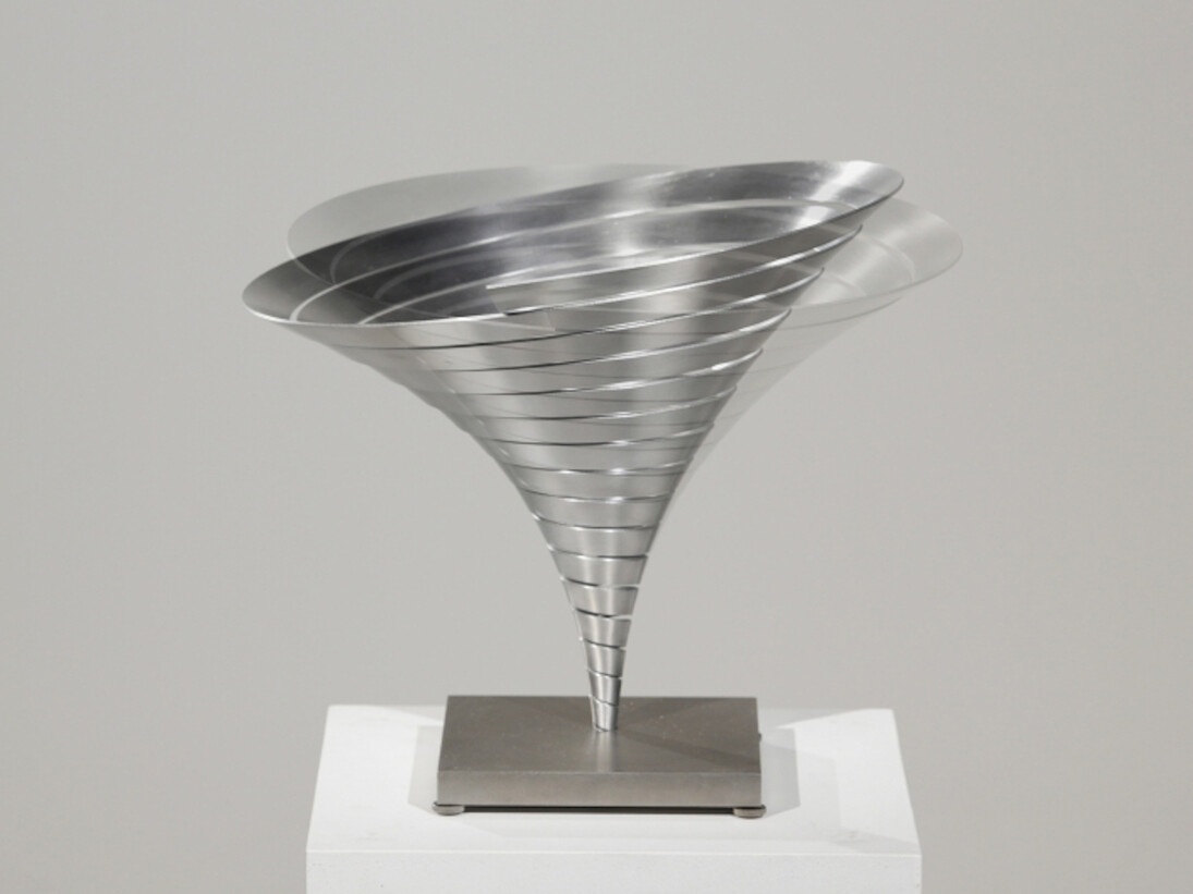 Martin Willing (b. 1958), Parabolkegel groß, 1991, Duraluminum, water jet cut, curved, prestressed, embedded in titanium plate, 11 3/8 (H) inches, 14 1/8 inches diameter. Courtesy of Hollis Taggart Galleries