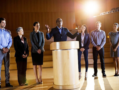 In a high-trust society, a person receiving an award symbolizes the positive outcomes of public trust in governance, which contributes to economic prosperity and helps address social inequality