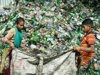 Sorting through discarded plastics, local residents embody the grassroots effort against corporate indifference to environmental degradation and public health