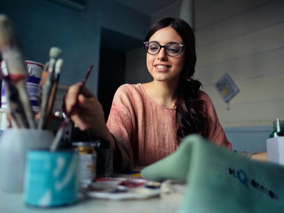 An artist smiling and working on a new project