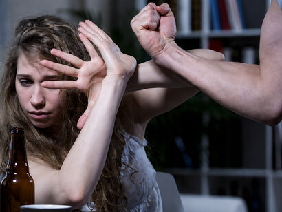 Woman shielding herself during a domestic violence incident at home