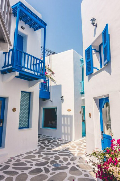 Breathtaking blue hues of the Aegean, where picturesque houses adorn the sun-kissed shores of Greece