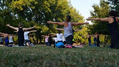 A group of people practicing yoga outdoors