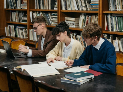 A group of students in a library. Studying with the goal of improving job-related skills is categorized as upskilling