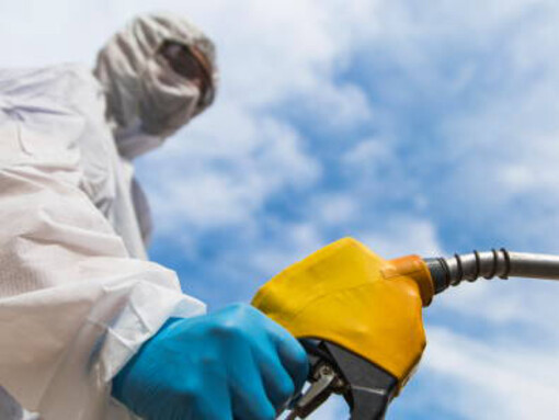 A gas station worker refuels a car during the COVID-19 pandemic amid the ongoing energy crisis