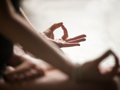 A woman practicing Padmasana with a mudra gesture, symbolizing her journey of self-discovery through hobbies and new experiences