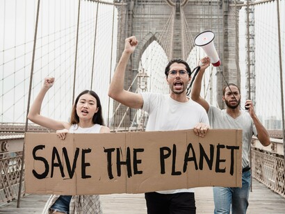Climate activists marching with calls to save the planet, representing growing public demands for environmental accountability
