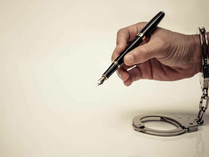 Handcuffed hands represent the constraints of censorship, emphasizing the fight to uphold press freedom and the fundamental right to free expression