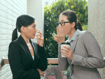 Asian women gossiping and judging, highlighting immigrant loneliness in Europe and the feeling of being out of place