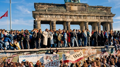 A section of the Berlin Wall is displayed through a permanent public photo exhibition near the Brandenburg Gate, commemorating the historic events of 1989 in Berlin, Germany