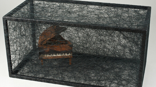 Chiharu Shiota, State of Being (Piano), 2014, metal, small piano and black thread, 30 x 60 x 30 cm - 11 3/4 x 23 5/8 x 11 3/42 in. Unique, © Sunhi Mang Courtesy Chiharu Shiota and Galerie Daniel Templon