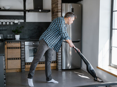 Man sweeping the house