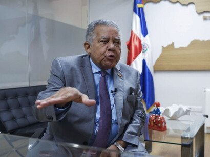 Juan Bolívar Díaz Santana speaks passionately from his office, embodying the same commitment to truth and diplomacy that has defined his illustrious career in journalism and international relations