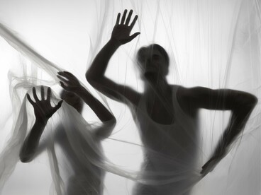 Veiled silhouettes moving spookily, symbolising how unspoken nightmares often lasts longer