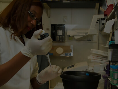 Chanelle Case Borden, Ph.D., a postdoctoral fellow in the Experimental Immunology Branch at the National Cancer Institute, meticulously dispenses DNA samples into a tube for a polymerase chain reaction (PCR), a fundamental laboratory method used to replicate specific segments of DNA