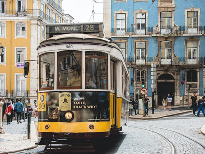 Yellow and white tram on the road in Lisbon, Portugal