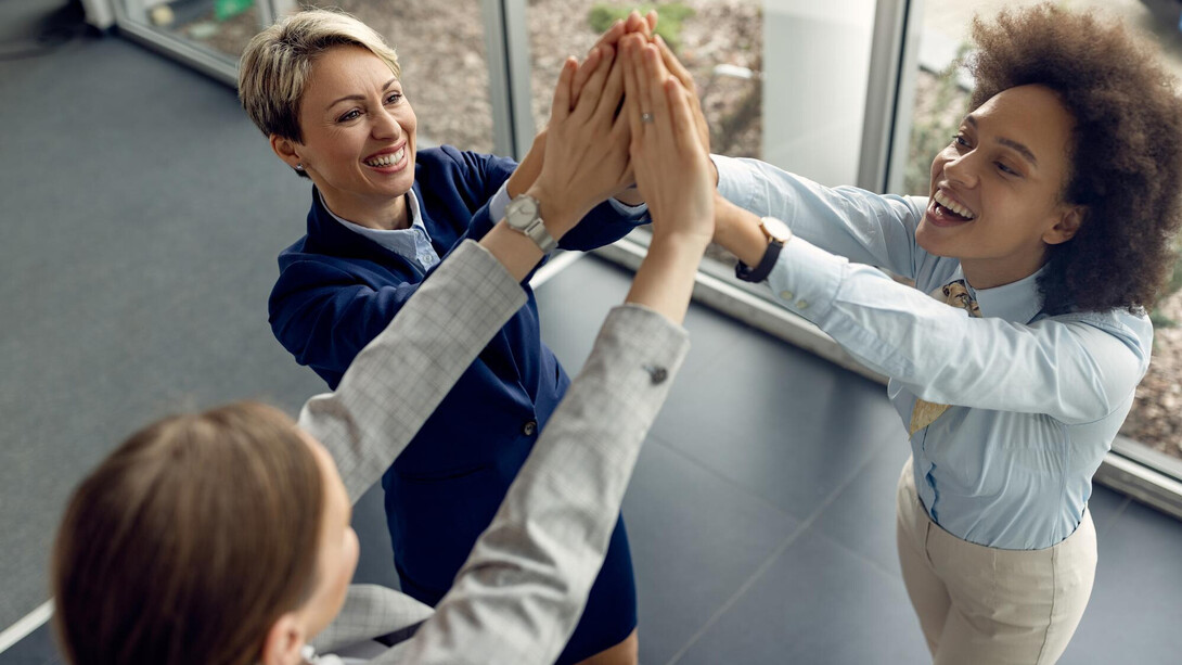 A group of employees sharing a happy moment during work hours
