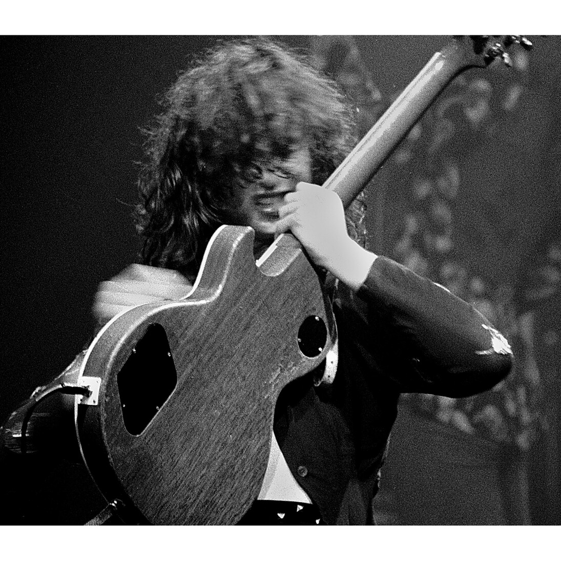 Jimmy Page biting guitar strings, Detroit, January 1975 © Michael Brennan, Courtesy of Proud Galleries