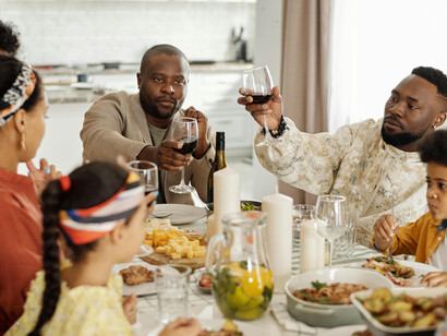 A family sits together at the dinner table, sharing a warm meal that reflects cultural traditions and togetherness