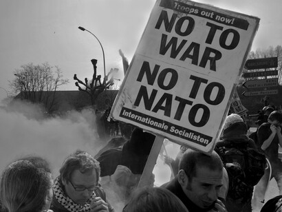 Protesters march against NATO policies during a public demonstration