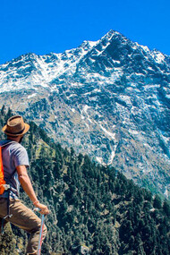 Gazing at the majestic mountain peaks, the traveler contemplates the awe-inspiring beauty of nature, ready to embark on an adventure that goes beyond mere sightseeing to embrace the ethos of sustainable travel