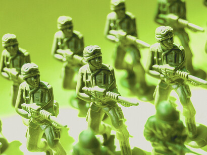 Miniature soldiers arranged in formation, symbolizing how war can turn individuals into anonymous units