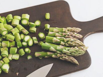 A visually appealing composition showcases fresh asparagus elegantly arranged on a wooden cutting board, embodying a culinary delight that harmonizes flavor and presentation