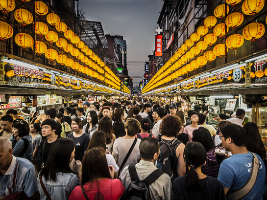 Crowds of tourists exploring the seafood night market in Keelung, Taiwan