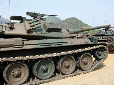 Heavy military tanks lined up on a training ground during readiness inspection